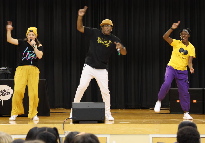 group of three performers doing hip hop for a school audience